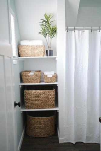 a bathroom with baskets and a plant at King Bed Near Lake w Fire Pit and Pack N Play in Sheboygan