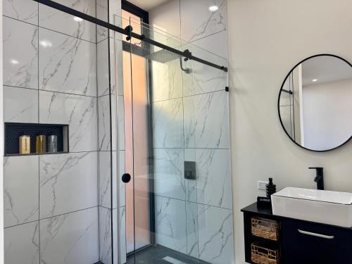a bathroom with a shower with a sink and a mirror at Ariché en Valle de Guadalupe in Valle de Guadalupe
