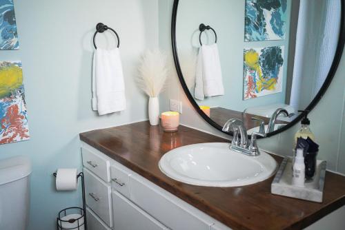 a bathroom with a sink and a mirror at King Bed Near Lake w Fire Pit and Pack N Play in Sheboygan