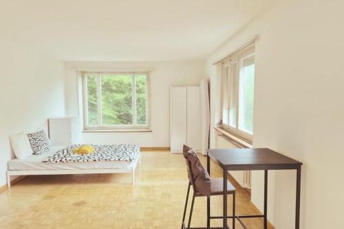 a living room with a couch and a table at City Center Flats with Balcony Garden View Rigi Self Checkin in Zurich