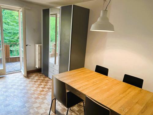 a dining room with a wooden table and chairs at City Center Flats with Balcony Garden View Rigi Self Checkin in Zürich