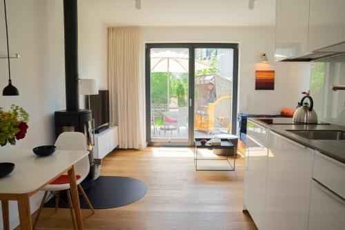 a kitchen with white cabinets and a dining table at SandDorn 1 und 2 in Pruchten