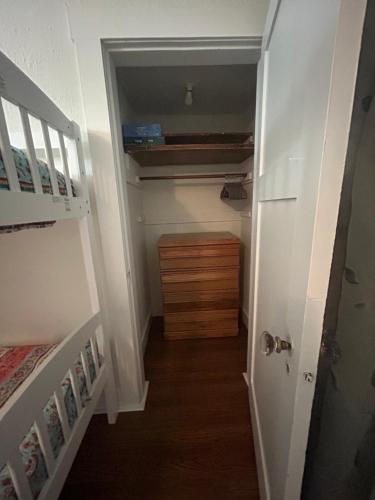 a hallway with a staircase and a dresser in a room at Colossal Craftsman in Hastings