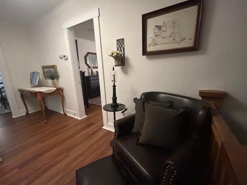 a living room with a leather couch and a table at Colossal Craftsman in Hastings