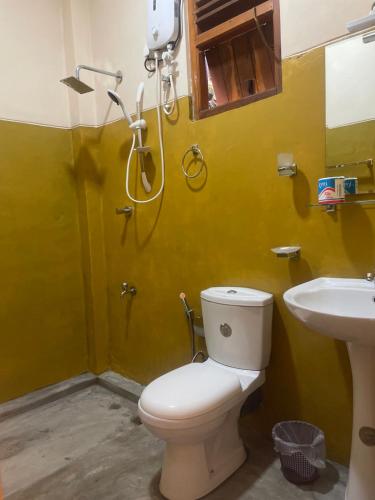 a bathroom with a toilet and a shower and a sink at Inside Out Nature Villa in Kandy