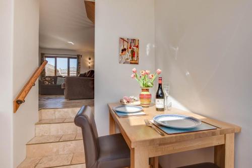a dining room with a table with a bottle of wine at The Hop House in Welcombe
