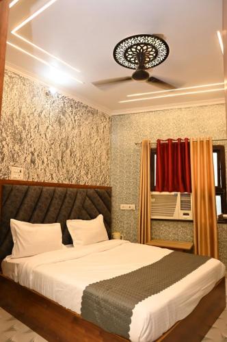 a bedroom with a bed and a ceiling at Sawaria Residency in Varanasi