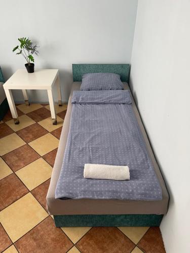 a bed in a room with a pillow on it at Lawendowa Przystań - Dolina Baryczy in Ujeździec Mały