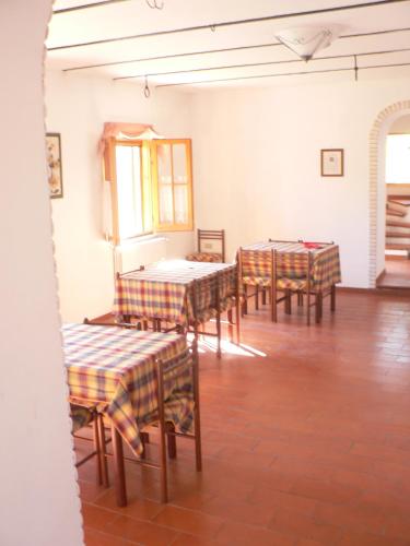 a group of tables and chairs in a room at Alloggio agrituristico Agripark in Armento