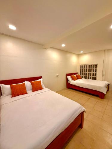a bedroom with two beds in a room at Casa Lina-San Juan, La Union in San Juan