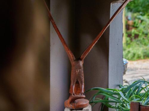 a brown vase sitting on the side of a wall at Phomola Manor Holiday Home in Phalaborwa