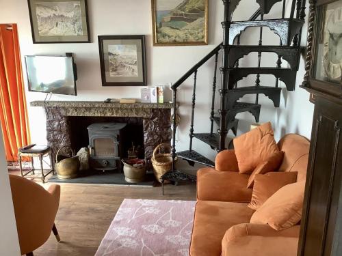 a living room with a staircase and a fireplace at The Magazine in Paul