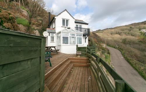 a house with a wooden deck with a fence at The Magazine in Paul