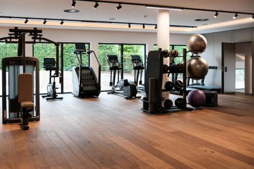 a gym with several exercise equipment in a room at Hotel Kaiser in Tirol in Scheffau am Wilden Kaiser