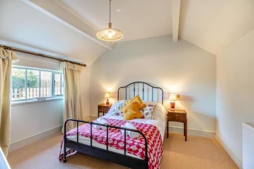 a bedroom with a bed and a window at Llangedwyn Smithy in Llangedwyn
