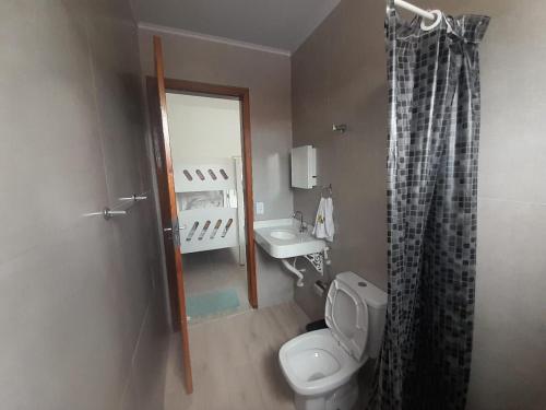 a small bathroom with a toilet and a sink at Flat novo 103 a pé da Prainha Mambucaba Paraty RJ in Paraty