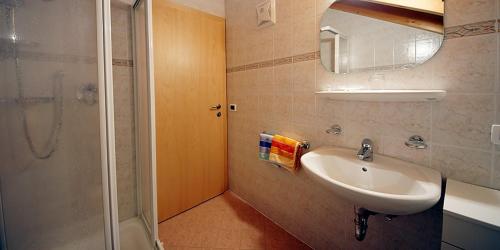 een badkamer met een wastafel en een douche bij Wirthof in La Valle