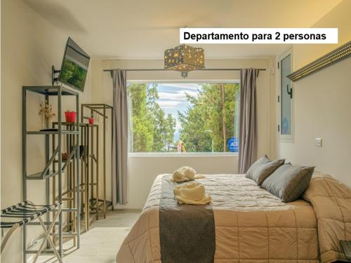 a bedroom with a bed with a teddy bear on it at Aucapillan in San Carlos de Bariloche
