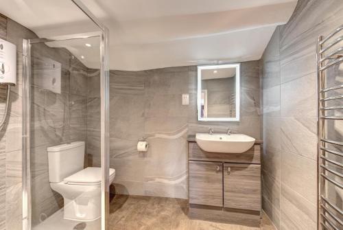 a bathroom with a toilet and a sink at Rose Cottage in Chapel Stile