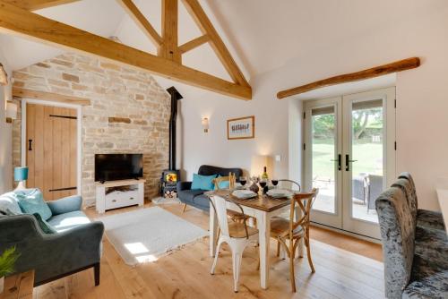a living room with a table and chairs at Hog Barn at Howe End in Castleton