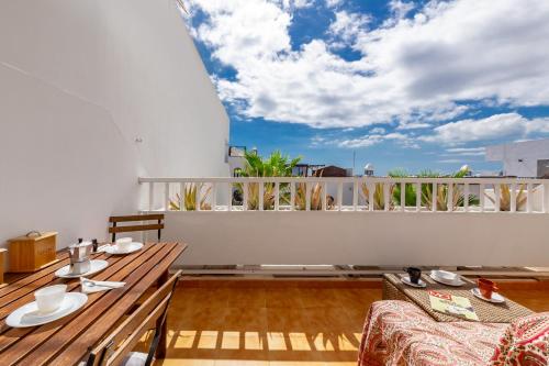 a balcony with a table and chairs and a view at The Colors House, 513 nice and cosy in Costa Teguise