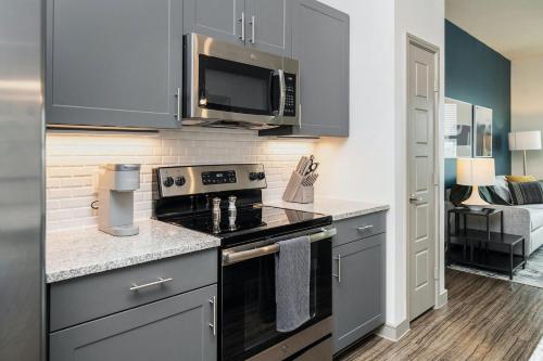 a kitchen with a stove and a microwave at Landing at Cove at Pine Ridge - 1 Bedroom in Lyman in Lyman