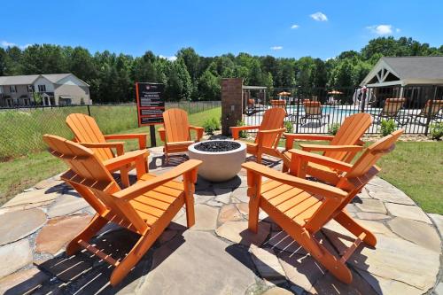 a group of wooden chairs sitting on a patio at Landing at Cove at Pine Ridge - 1 Bedroom in Lyman in Lyman