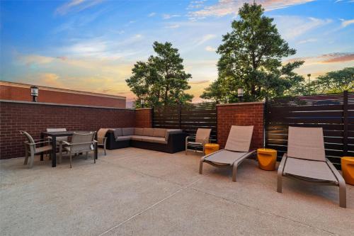 a patio with chairs and tables and a couch at Drury Plaza Hotel St Louis Creve Coeur in Creve Coeur