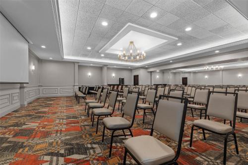 a room with rows of chairs and a podium at Drury Plaza Hotel St Louis Creve Coeur in Creve Coeur