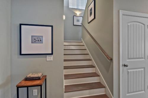 a hallway with a staircase with a white door at Marsh Views On Holly in Ebo Landing