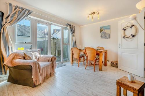 Beachside Cottage في Camber: غرفة معيشة مع طاولة وغرفة طعام
