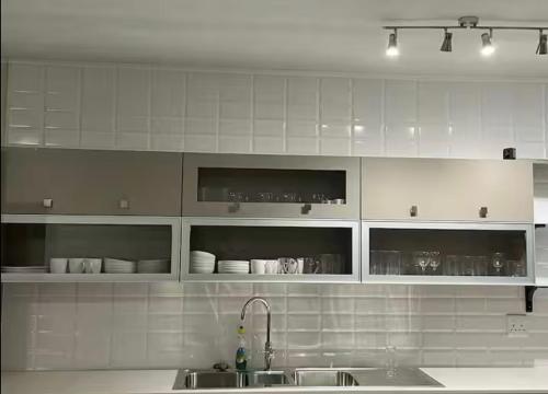 a kitchen with white cabinets and a sink at Wildlife Oasis in Marloth Park