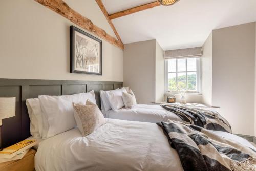 a room with three beds and a couch at Undergarth Cottage in Chapel Stile