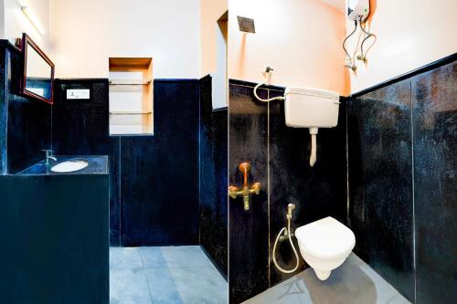 a bathroom with a toilet and a sink at Super Hotel O Chrompet Near Rela Hospital in Chennai