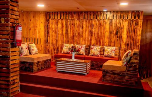 a room with two couches and a table in a room at Hotel Greenwich in Kigali