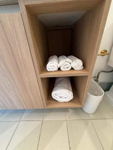 a cabinet with rolled towels in a bathroom at Stunning Lux 2 Bed 2 Bath with Panoramic View from Balcony in Miami