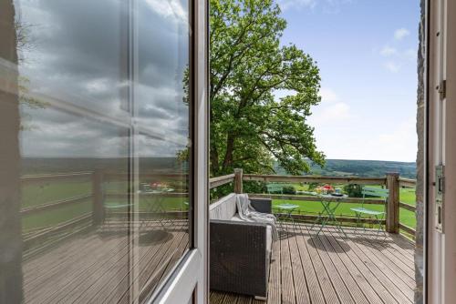 a balcony with a view of a wooden deck at The Gate Lodge Brynteg in Llanwenog