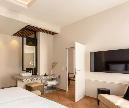 a bedroom with a bed and a large mirror at LOVIS Suites Vienna in Vienna