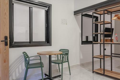 a table and chairs in a room with a window at NOK Home Tree Living in Medellín