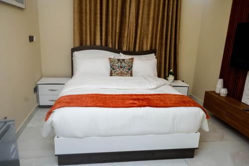a bedroom with a large white bed and a window at Luxury 3BR Villa with smart Lock , Fast Wifi, Sure Parking in Oyarifa, Accra in Accra