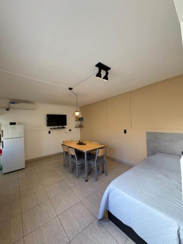 a room with a bed and a table and a tv at Complejo Sucre I in San Luis