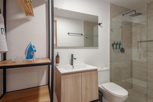 a bathroom with a sink and a toilet and a shower at NOK Home Tree Living in Medellín