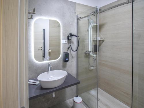 a bathroom with a sink and a shower at Casa Muntenească Alessandro in Piteşti