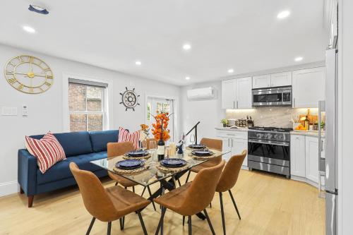 a living room with a blue couch and a table and chairs at North End Entire House in Boston