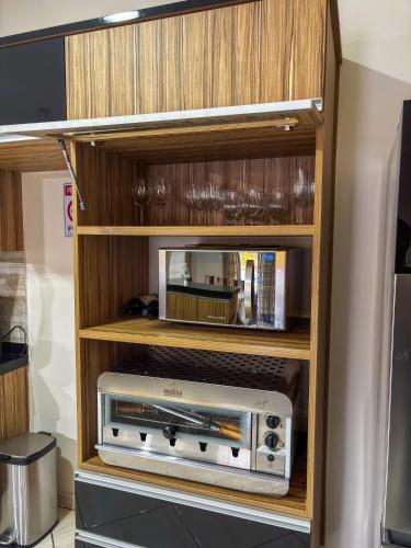 a wooden entertainment center with a radio in it at Chácara Pôr do Sol in Andradas