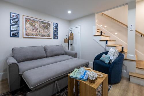 a living room with a couch and stairs at North End Entire House in Boston