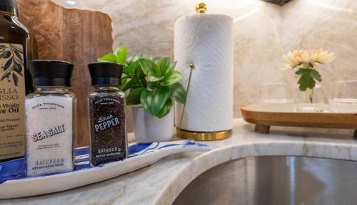 a bathroom counter with two bottles of essential oils and a sink at North End Entire House in Boston