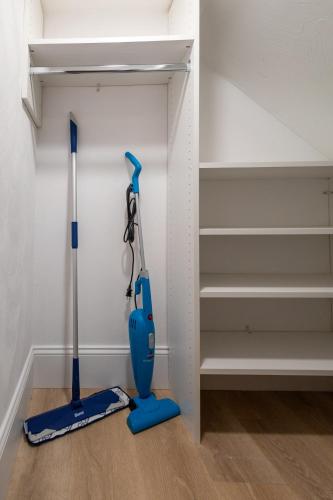 two vacuum cleaners in a room with shelves at North End Entire House in Boston