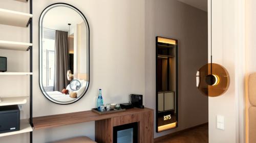 a living room with a mirror and a fireplace at LOVIS Suites Vienna in Vienna