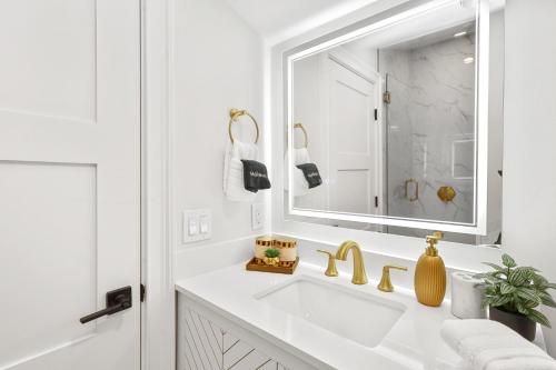 a white bathroom with a sink and a mirror at North End Entire House in Boston